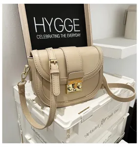 Chic women beige saddle bag, stylish PU leather shoulder crossbody bag for daily casual wear.