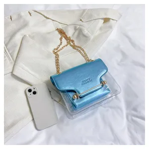Clear crossbody bag with metallic blue flap and gold chain strap for women chic daily style.