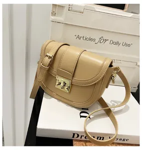 Detailed view of the elegant beige saddle bag featuring premium PU leather and gold hardware.