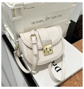 Chic minimalist white women saddle bag, elegant PU leather crossbody bag with gold lock.