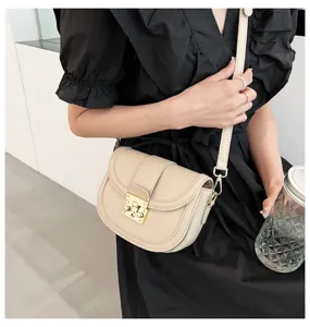 Beige women saddle bag detail, stylish PU leather crossbody shoulder bag with metal lock.