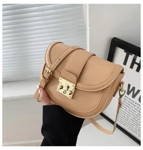 Stylish beige saddle bag for women, chic PU leather shoulder crossbody bag with gold lock.
