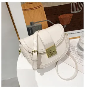 Elegant minimalist white saddle bag for women featuring gold lock hardware and adjustable strap.