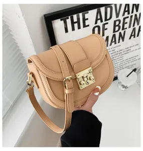 Detailed view of a chic beige saddle bag with metal lock and double strap, stylish daily wear.