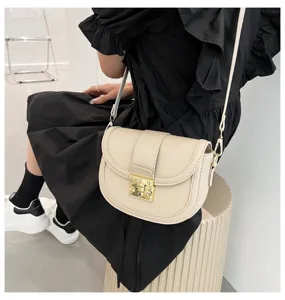 Chic minimalist women saddle bag, elegant shoulder crossbody bag with gold hardware styling.