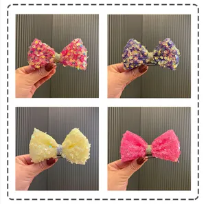Kids sequin bow hair clips detail view, sparkling princess hair accessories for cute styling.