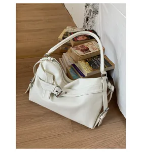 White retro motorcycle shoulder bag, PU leather underarm tote with chic buckle strap detail.