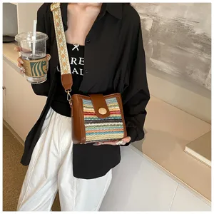 Stylish women's woven bucket bag with wide strap, casual striped crossbody bag for daily use.