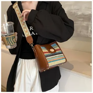Woven bucket shoulder bag with wide strap, trendy crossbody bag for women, detail view.