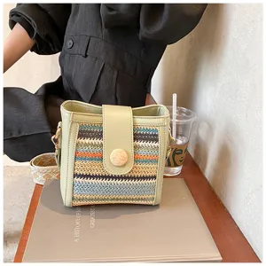 Detailed view of the stylish woven bucket bag featuring colorful patterns and wooden button.