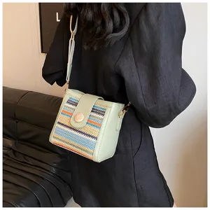 Woven bucket shoulder bag for women, trendy crossbody bag with wide strap and chic flap.