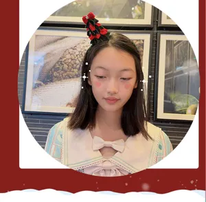 Detail shot of Christmas tree headband with velvet bow, perfect festive hair accessory for kids.