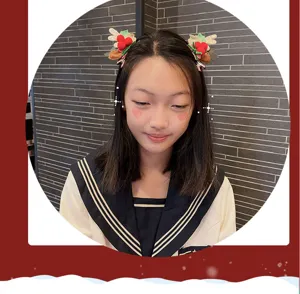Detailed view of Christmas hair clip with cute pom-pom and bow design for festive holiday wear.