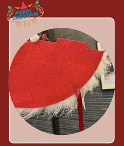 Close-up detail of Christmas headband red felt fabric with white feather trim and bow.