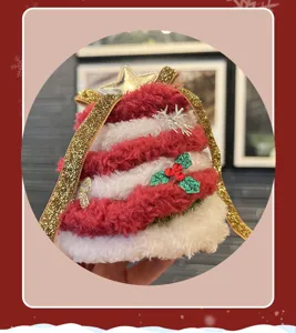 Plush Christmas tree headband detail, red and white striped hair accessory with stars.