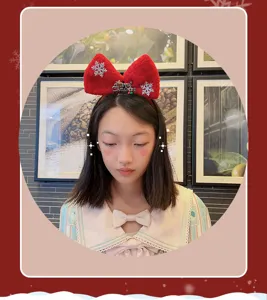Christmas red bow headband with glitter snowflake and letter decor for holiday party wear.