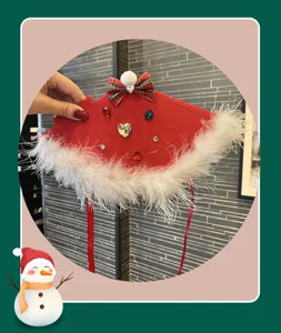 Christmas red felt cape detail, white feather trim and bow rhinestone decor close up view