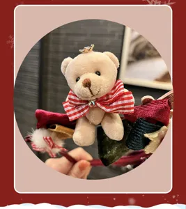 Detailed close-up of cute plush bear Christmas headband featuring red plaid bow and crown for kids.