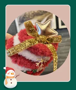 Close-up detail of the Christmas plush hair clip featuring a golden star and glitter bow.