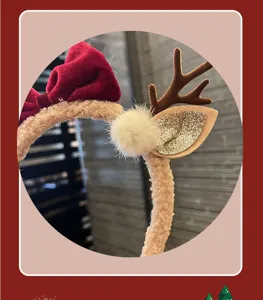 Christmas reindeer antler headband detail, red velvet bow and glittering plush ears.