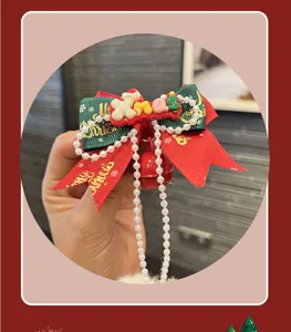 Christmas bow hair clip with pearls and bell, perfect cute holiday hair accessory for girls.