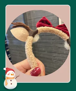 Christmas reindeer headband detail close-up fuzzy fabric red velvet bow hair accessory