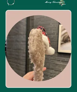 Plush Christmas hair hoop detail showing soft brown faux fur texture and red plaid hat decor.