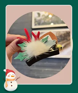 Christmas deer antler children hair clip with cute bell and plush pompom decoration.