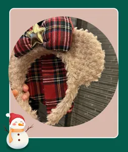 Detailed closeup of cute autumn winter plush bow hair hoop featuring plaid and gold star.