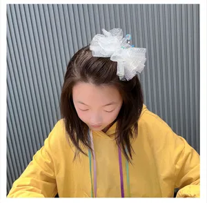 Glittering white mesh bow hair clip detail presentation, cute princess hair accessory for girls.