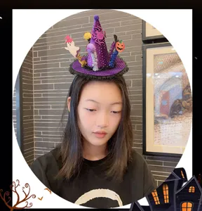 Close-up detail of the Halloween witch hat headband, featuring cute spider and pumpkin decor.