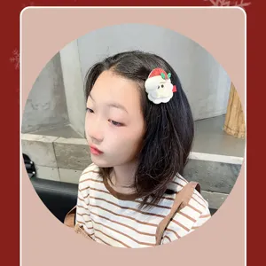 Detailed view of cute Santa Claus hair clip worn by a child, festive Christmas design.