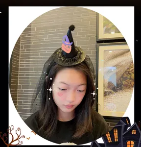 Halloween witch hat headband detail view, black mesh and cute pumpkin decor for kids party.