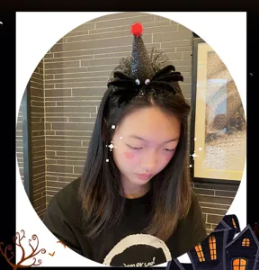 Halloween spider witch hat headband detail shot, black glitter party hair accessory for girls.