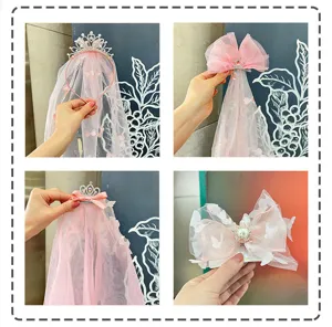 Detail shot of cute kids pink crown veil headband and bow hair clips for party and stage.