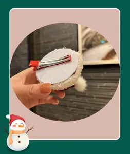 Christmas red hat hair clip detail showing back metal alligator clip and plush backing.