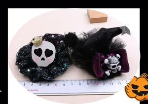 Close-up detail of Halloween hair accessories featuring skull design and witch hat elements.
