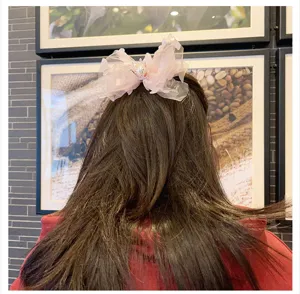 Charming children bow hair clip with pink tulle mesh and pearl details, sweet hair accessory.
