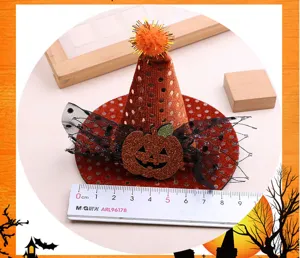 Detail of Halloween witch hat hair clip with pumpkin and mesh bow, cute party accessory.