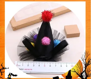 DIY Halloween mini witch hat hair clip accessory with colorful pom-poms and black tulle.