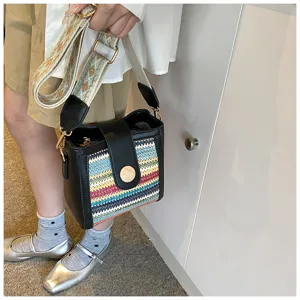 Detailed view of women fashion woven bucket shoulder bag with wide strap for daily style.