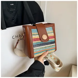 Crossbody woven bucket bag for women, stylish colorful shoulder bag with wide strap.