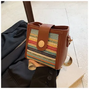 Woven bucket bag for women with PU leather trim and wide strap, stylish casual crossbody bag.