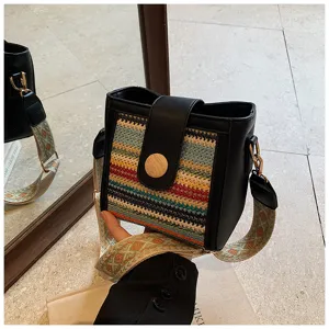 Woven bucket shoulder bag for women, stylish crossbody handbag with wide strap.
