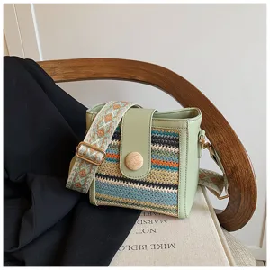 Woven bucket crossbody bag detail, green PU leather trim, ethnic wide strap, stylish.