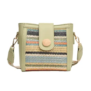 Fashion woven bucket bag for women, stylish crossbody shoulder bag with wide strap design.