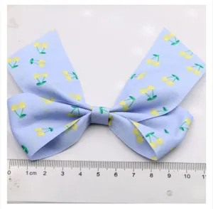 Cute light blue cherry bow hair clip for girls, handmade DIY hair accessories detail view.