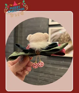 Detailed view of a retro Christmas bow hair clip with cute plush bear and checkered balls.
