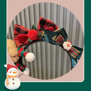 Christmas plaid bow headband detail view, festive red and green hair hoop with cute Santa.