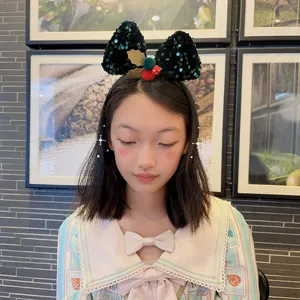 Children's Christmas glitter bow headband with red and green sequin design for girls' festive dress.